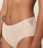 Model close-up side view of the Triumph Flex Smart beige maxi panty, showing the high-waisted design and smooth, neutral stretch fabric. Available for Online Purchase