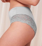Model close-up side view of the Triumph Ladyform Soft light grey maxi panty, highlighting the high-waisted fit and delicate lace side inserts. Find Now Online