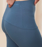 Model close-up side view of the Triumph Natural Spotlight blue rib comfort stretch trousers, highlighting the pregnancy-friendly waistband and wide-leg cut. Shop Online