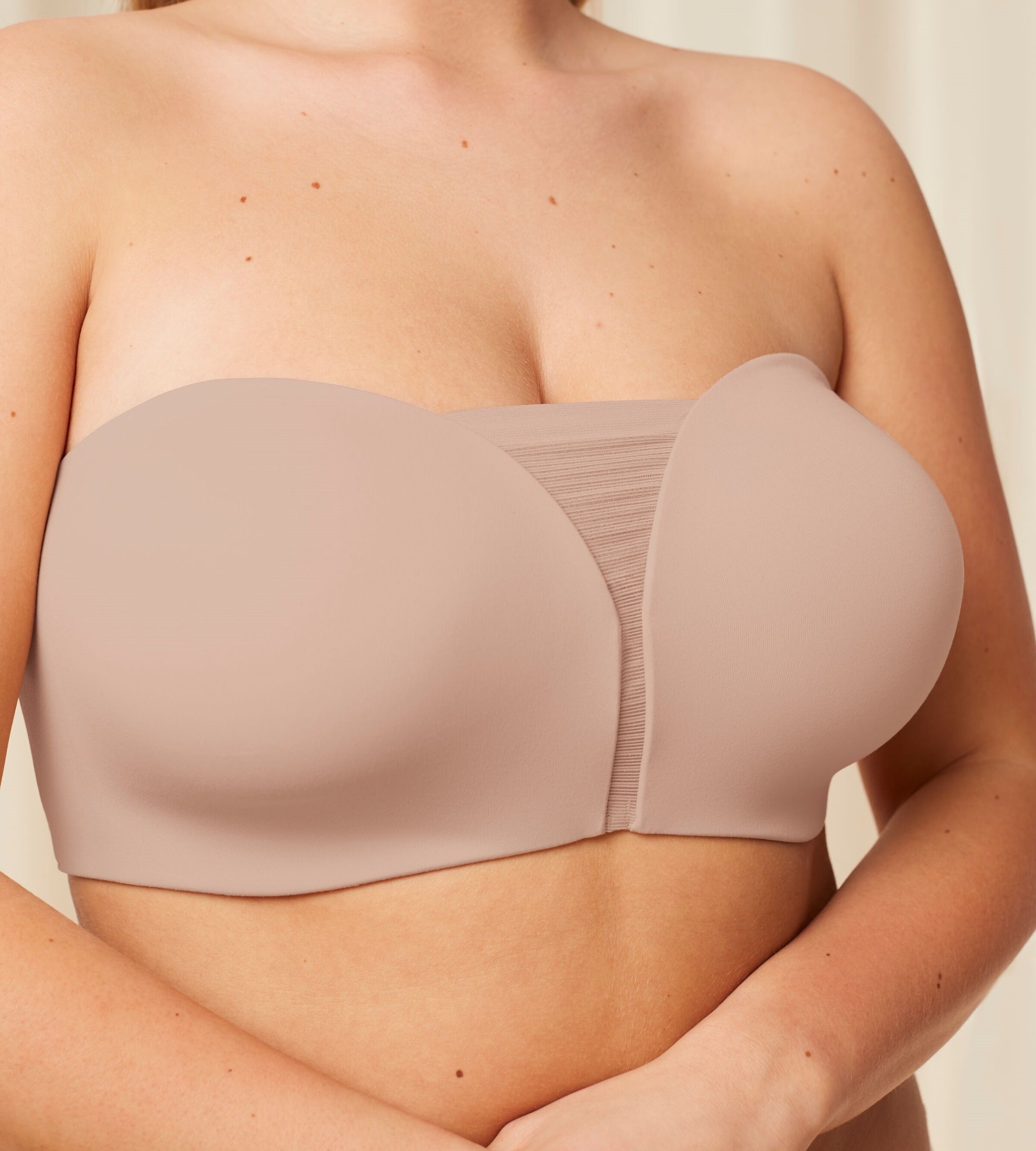 Model close-up view of the Triumph Flex Smart beige non-wired bra with detachable straps and a smooth, seamless finish. Shop Online Today