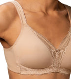 Model close-up view of the Triumph Modern Lace+Cotton beige non-wired bra, showcasing the cotton cups and decorative floral lace. Shop the Latest Online