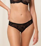 Model front view of the Triumph Amourette Charm Brazilian panties in black lace, showing the cheeky cut and flat-seam design. Shop Online at Blue Salon Qatar
