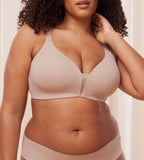 Model front view of the Triumph Fit Smart beige non-wired bra, highlighting the stretchable lace design and wireless comfort construction. Available Online Now