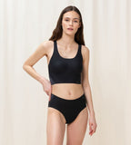 Model front view of the Triumph Flex Smart black pull-on bra top, highlighting the smooth neckline and flexible, wire-free design. Order Online Today