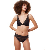 Model front view of the Triumph Hypnotic Spotlight black plunge bra, showing the deep V-neckline and intricate geometric lace. Order Online Today