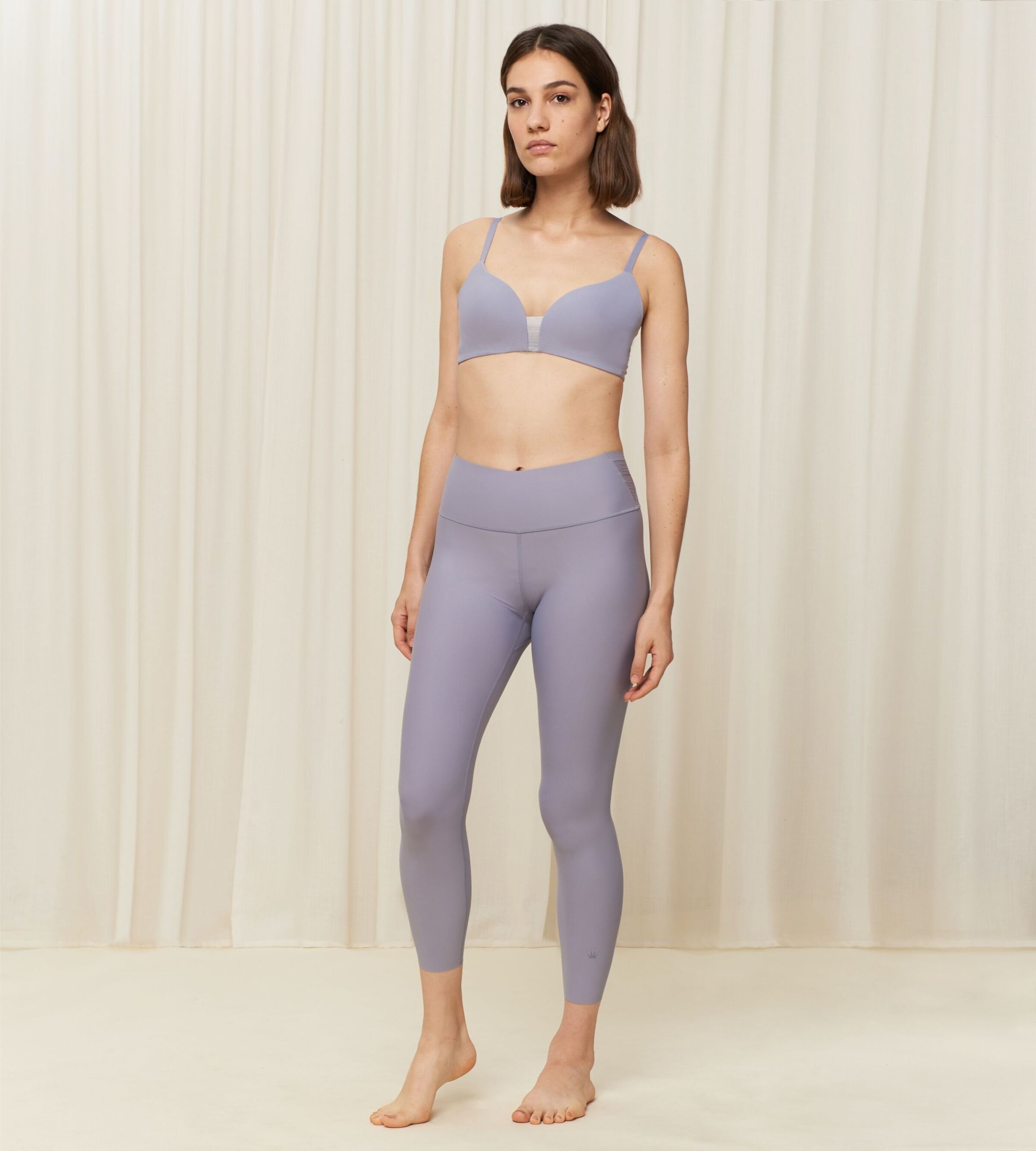 Model full front view of the Triumph Flex Smart Morandi Grey sports leggings, showing the high-waisted fit and smooth, seamless construction. Shop Now Online