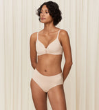 Model full front view of the Triumph Flex Smart beige maxi panty, showing the high-waisted design and smooth, neutral stretch fabric. Available for Online Purchase