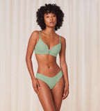 Model full front view of the Triumph Flex Smart green high-leg Brazilian panty, showcasing the smooth elastic fabric and modern silhouette. Now Available Online
