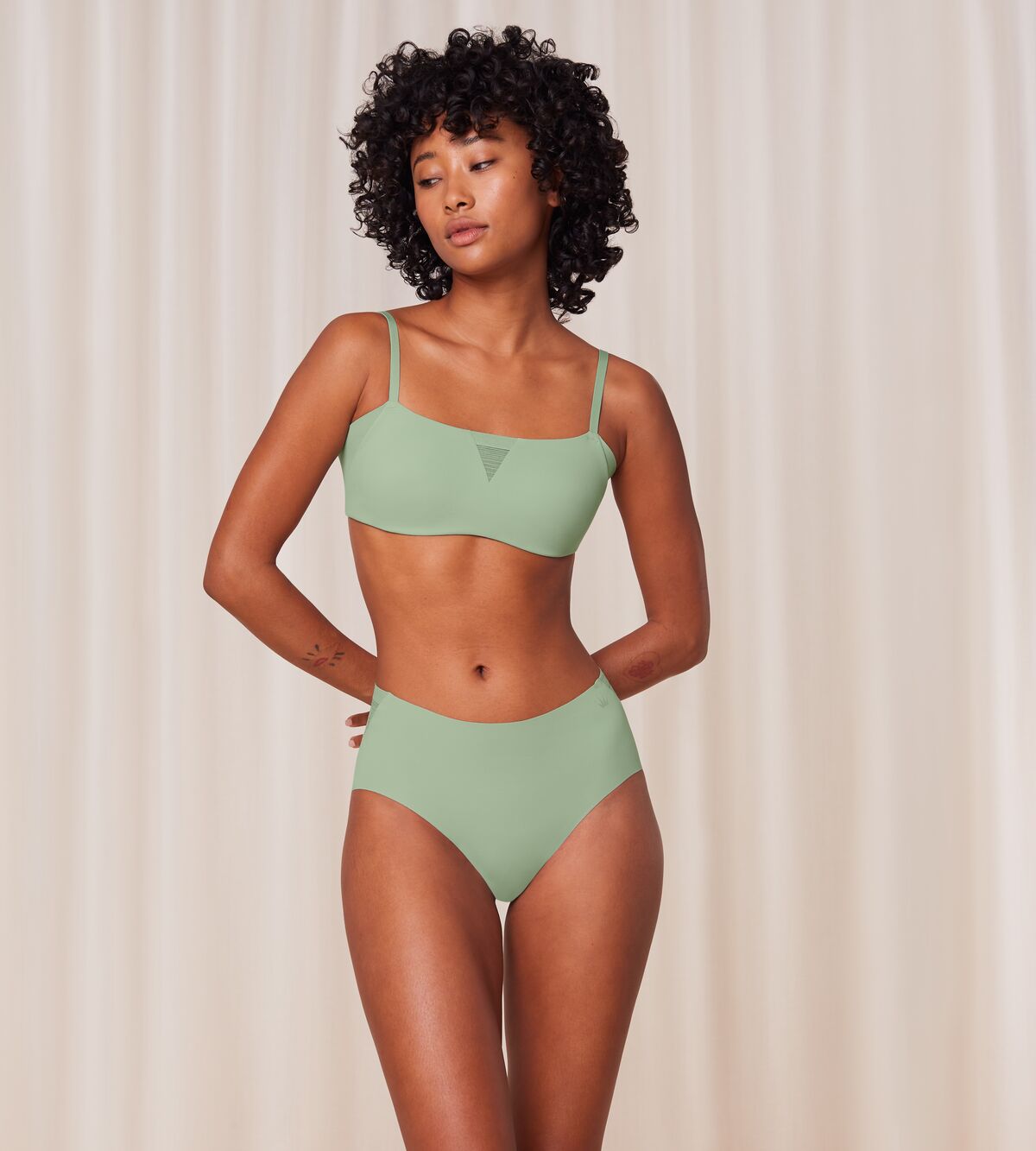 Model full front view of the Triumph Flex Smart green maxi panty, highlighting the high-waisted silhouette and smooth, vibrant stretch fabric. Shop Online Now
