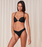 Model full front view of the Triumph Harmony Spotlight black push-up bra, showcasing the graphic lace and front-fastening detail. Available Online