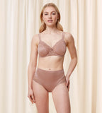 Model full front view of the Triumph Ladyform Soft light brown maxi panty, showing the high-waisted cut and delicate lace side panels. Shop Online Today