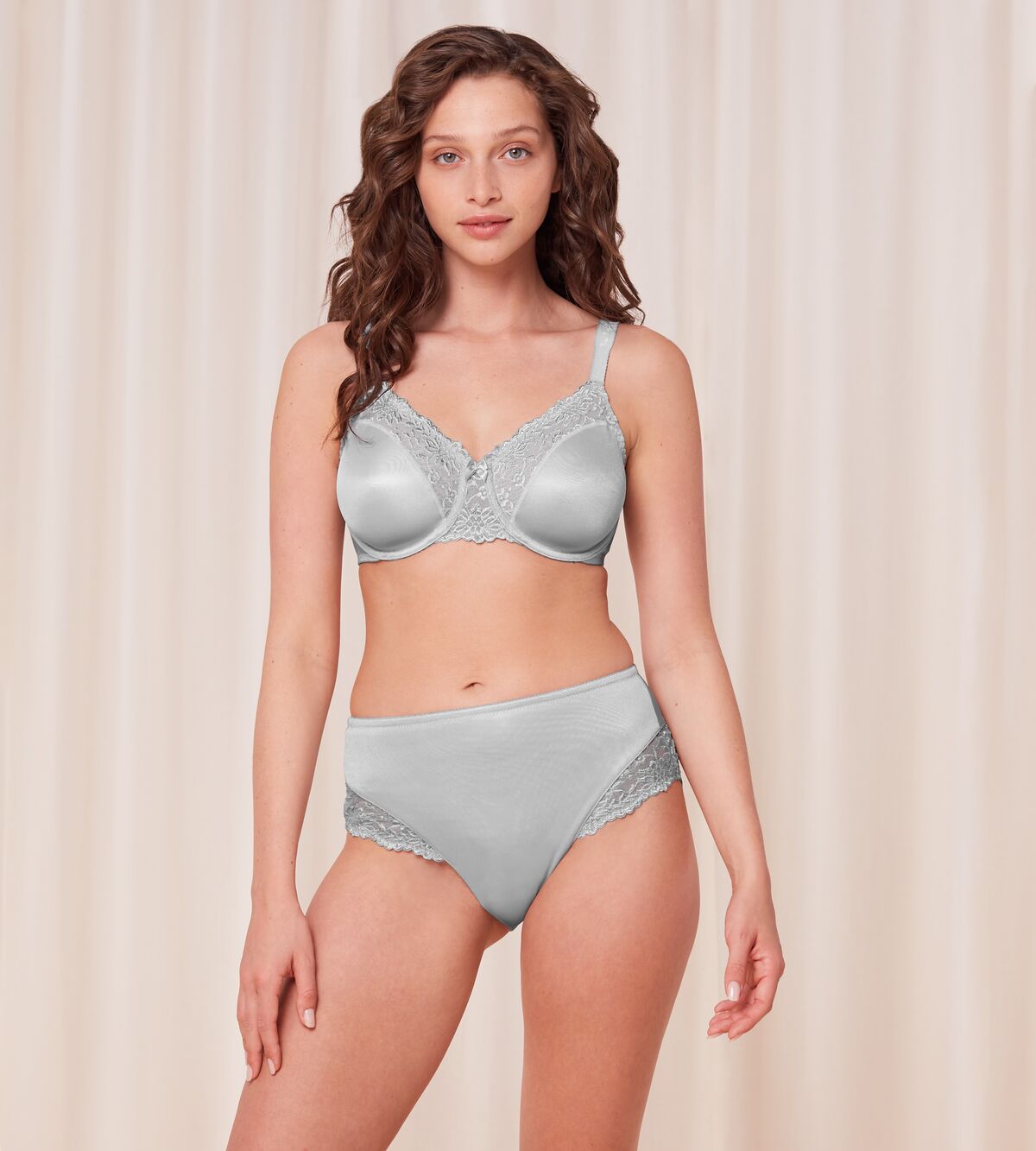Model full front view of the Triumph Ladyform Soft light grey maxi panty, highlighting the high-waisted fit and delicate lace side inserts. Find Now Online