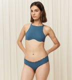 Model full front view of the Triumph Natural Spotlight blue hipster panty, showing the low-rise fit and flat lace detailing at the legs. Shop Now Online
