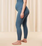Model second side view of the Triumph Natural Spotlight blue rib comfort stretch trousers, highlighting the pregnancy-friendly waistband and wide-leg cut. Shop Online