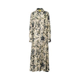 A full-length view of a Momonì long-sleeved maxi shirt dress featuring a cream-colored base with an intricate dark blue and sage green floral botanical print, displayed against a white background.