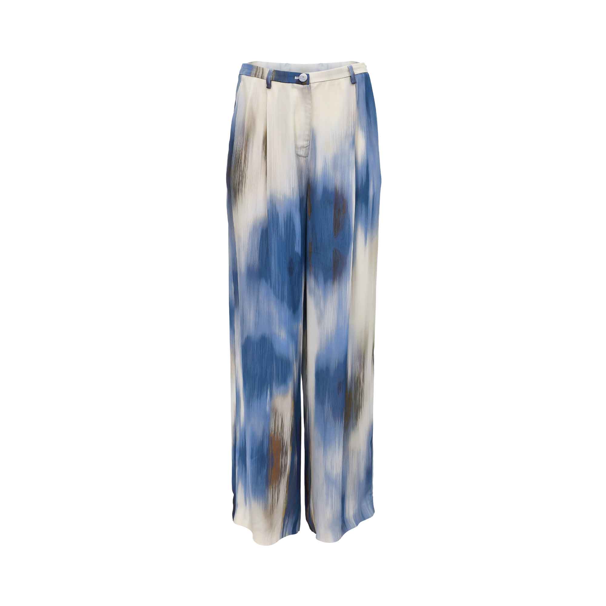 Front view of a pair of women's Momonì wide-leg trousers featuring a blue and cream abstract watercolor tie-dye print, detailed with front pleating, belt loops, and a single-button waistband closure.