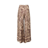 Momoni high-waisted wide-leg trousers featuring a vintage-style floral print in burgundy and tan. The pants have front pleats and a decorative border print at the hem, displayed against a white background.