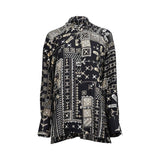 Front view of a black MOMONI long-sleeved shirt featuring a cream-colored ethnic geometric and floral print with a mandarin collar.