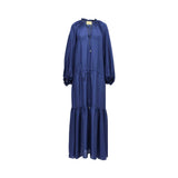Front view of a Momoni rust blue silk maxi dress on a mannequin, showcasing the ruffled tie neckline, drawstring waist, and tiered hem.