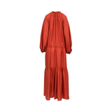 Back view of the Momoni rust blue maxi dress highlighting the fluid silk fabric and the gathered detail at the high neckline and waist.