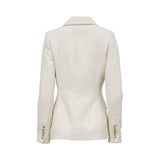 Back view of a tailored ivory bouclé blazer by MOONMAINS showing a structured waist and gold button cuff details.