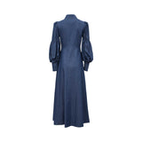 Rear view of the MOONMAINS indigo gown showing the structured back, high collar, and the flowing A-line skirt.