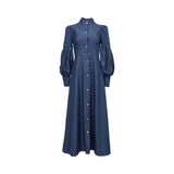 A full-length front view of a dark indigo MOONMAINS maxi gown featuring a high collar, gold buttons, and dramatic bishop sleeves.