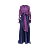 Front view of a floor-length MOONMAINS gown featuring a purple V-neck bodice, navy blue skirt, laser-cut sleeves, and a large purple front sash.