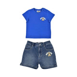 A two-piece Moschino Baby set featuring a royal blue T-shirt with a Teddy Bear logo and matching mid-wash blue denim shorts.