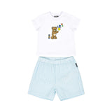 A baby's two-piece designer set featuring a white T-shirt with a teddy bear blowing bubbles and light blue gingham checkered shorts.
