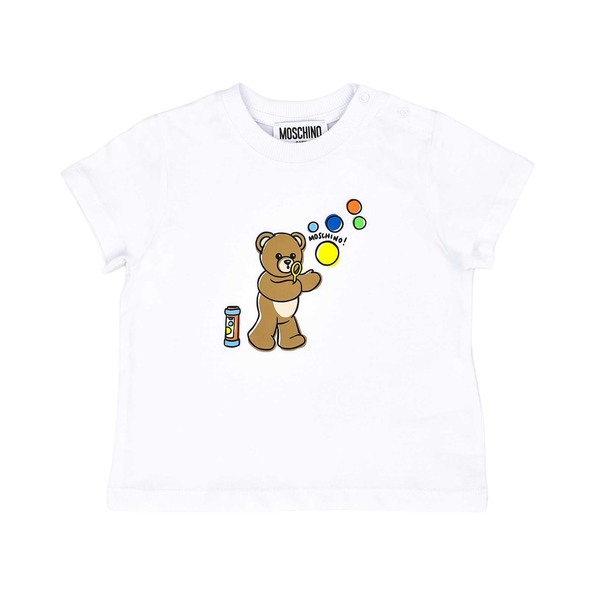 Detailed front view of the white T-shirt highlighting the colorful bubble-blowing teddy bear graphic and snap-button shoulder.