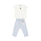 A Moschino Baby two-piece outfit featuring a white T-shirt with a teddy bear logo and blue-and-white striped linen trousers.
