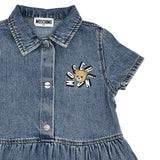 Close-up of the bodice highlighting the Moschino Kid neck label, silver-tone buttons, and the sunburst Teddy Bear logo embroidery.