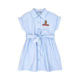 Front view of a light blue kids' shirtdress featuring a button-down front, waist tie belt, and a Teddy Bear embroidery on the chest.
