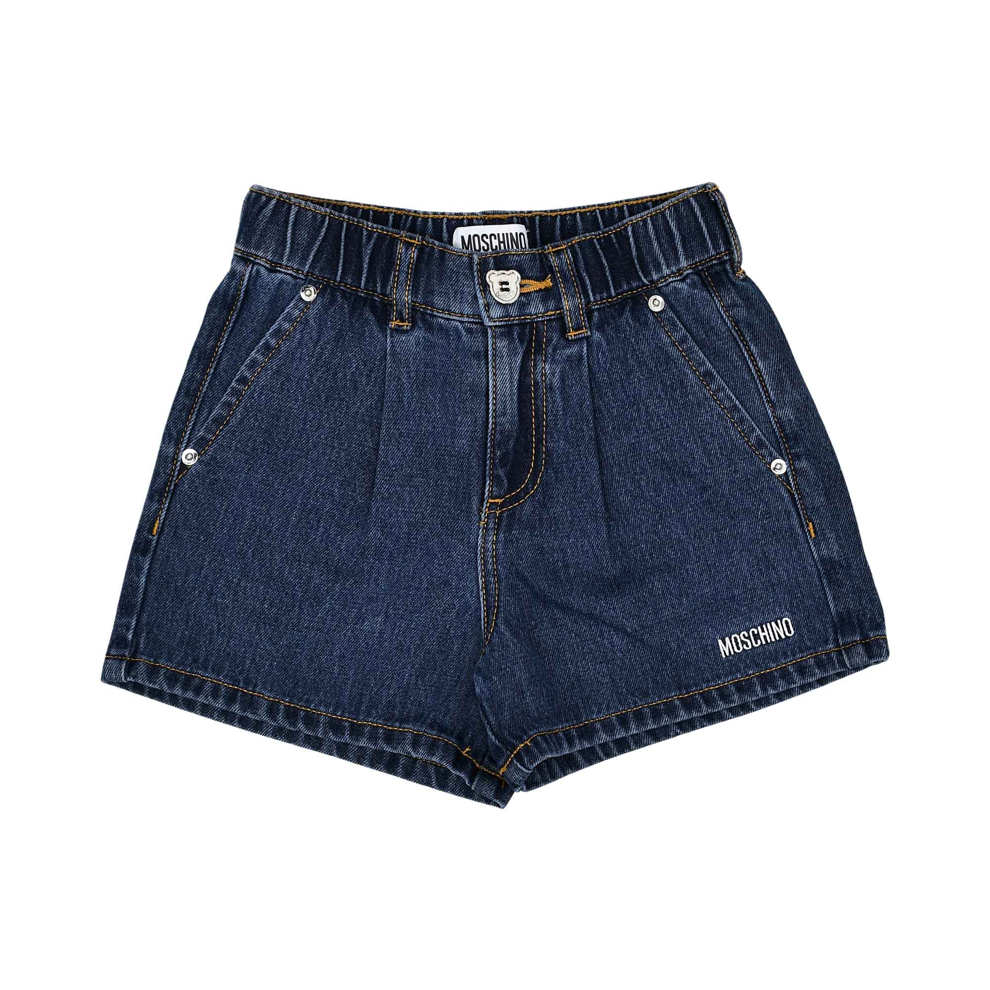 Close-up of the dark-wash denim shorts featuring a teddy bear button and white logo branding.