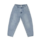 Close-up of the front of the light-wash denim jeans showing the elasticated waist, pleats, and white button.