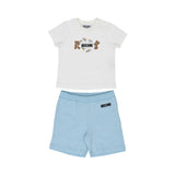 Front view of a Moschino Baby two-piece set featuring a white T-shirt with a paper plane Teddy Bear graphic and sky blue cotton shorts.