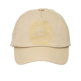 Frontal view of a beige Moschino Kids baseball cap showcasing a tonal, circular repeat logo printed on the center crown.