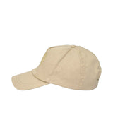 A right-side angled view of the beige cotton cap, highlighting the curved brim and the subtle texture of the circular logo design.