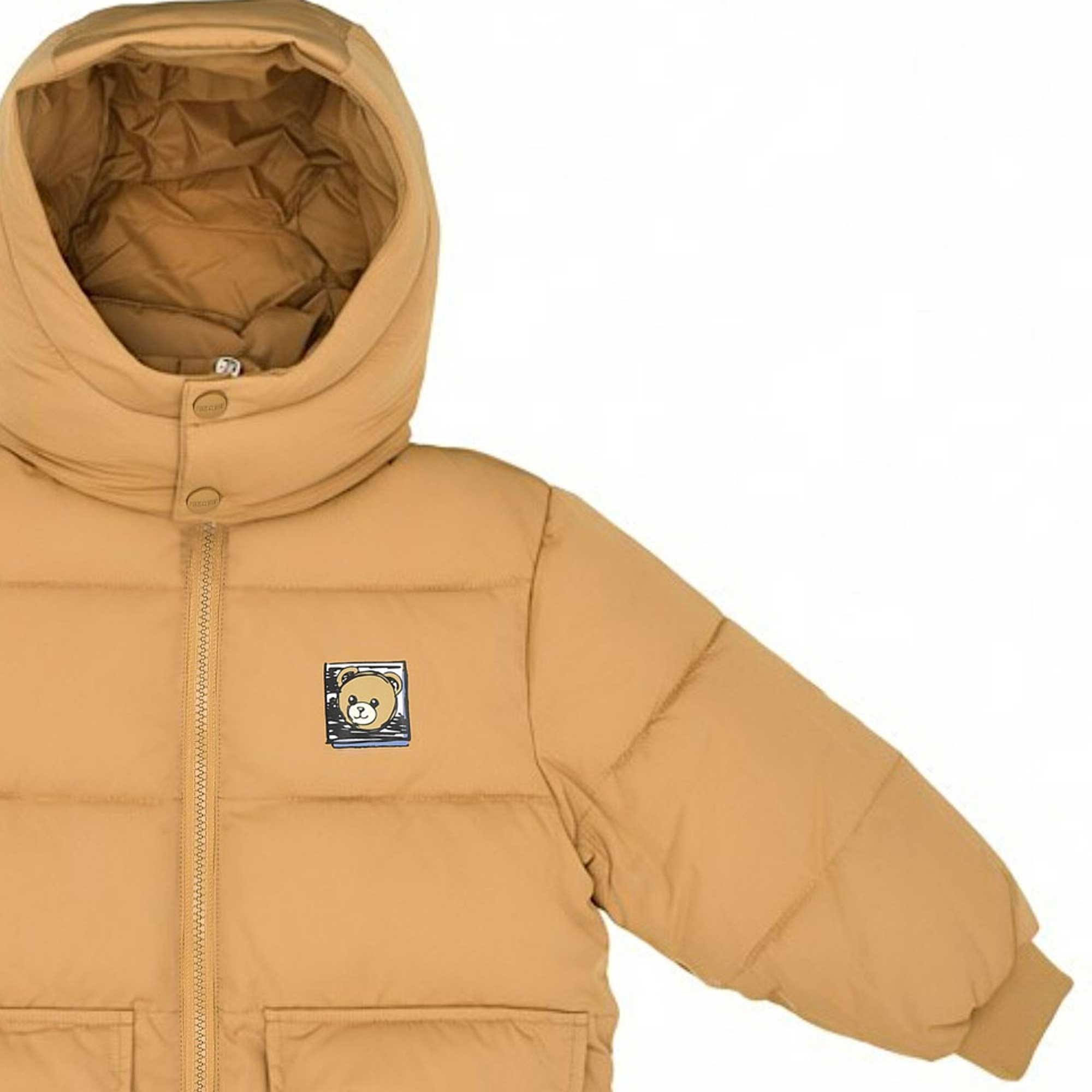 Detail view of the upper section of the Moschino Kids puffer jacket, highlighting the double-button snap closure on the hood collar and the square signature Teddy Bear embroidered patch.