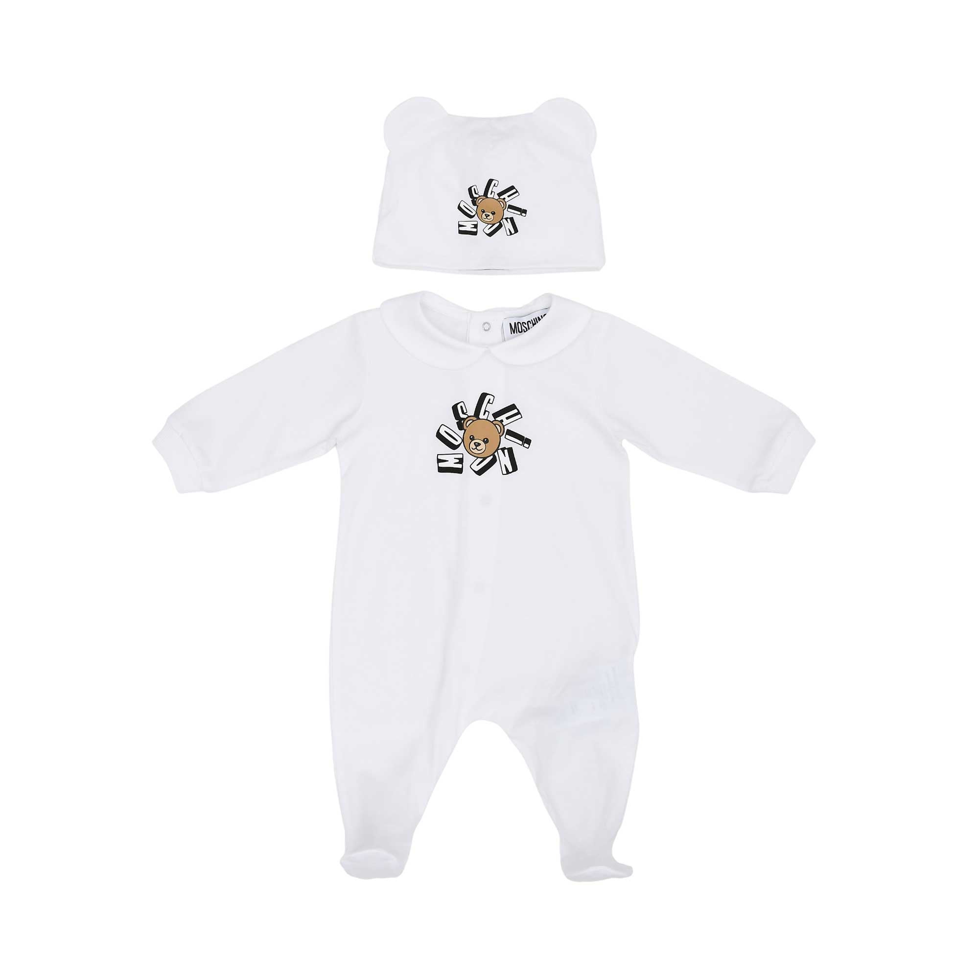 Front view of a white Moschino Kids babygrow with a Peter Pan collar and a matching white hat with bear ears, both featuring the Teddy Bear logo