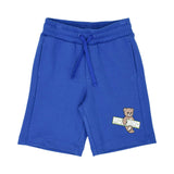 Front view of the blue Moschino shorts featuring a drawstring waist and Teddy Bear graphic on the left leg.