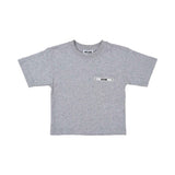 Front view of a grey Moschino Kids T-shirt featuring a chest pocket with a black logo tape and silver studs.