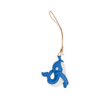 A handcrafted blue and white leather whale charm by MUNI, featuring white contrast stitching and a tan leather hanging loop, isolated on a white background.