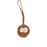 A brown circular leather bag charm designed to look like a cookie character with large white eyes and colorful sprinkles, featuring a long leather attachment loop, by the brand MUNI.
