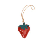 A handcrafted red leather strawberry charm by MUNI, featuring a green leaf top, white dot details, and a tan leather hanging cord against a white background.