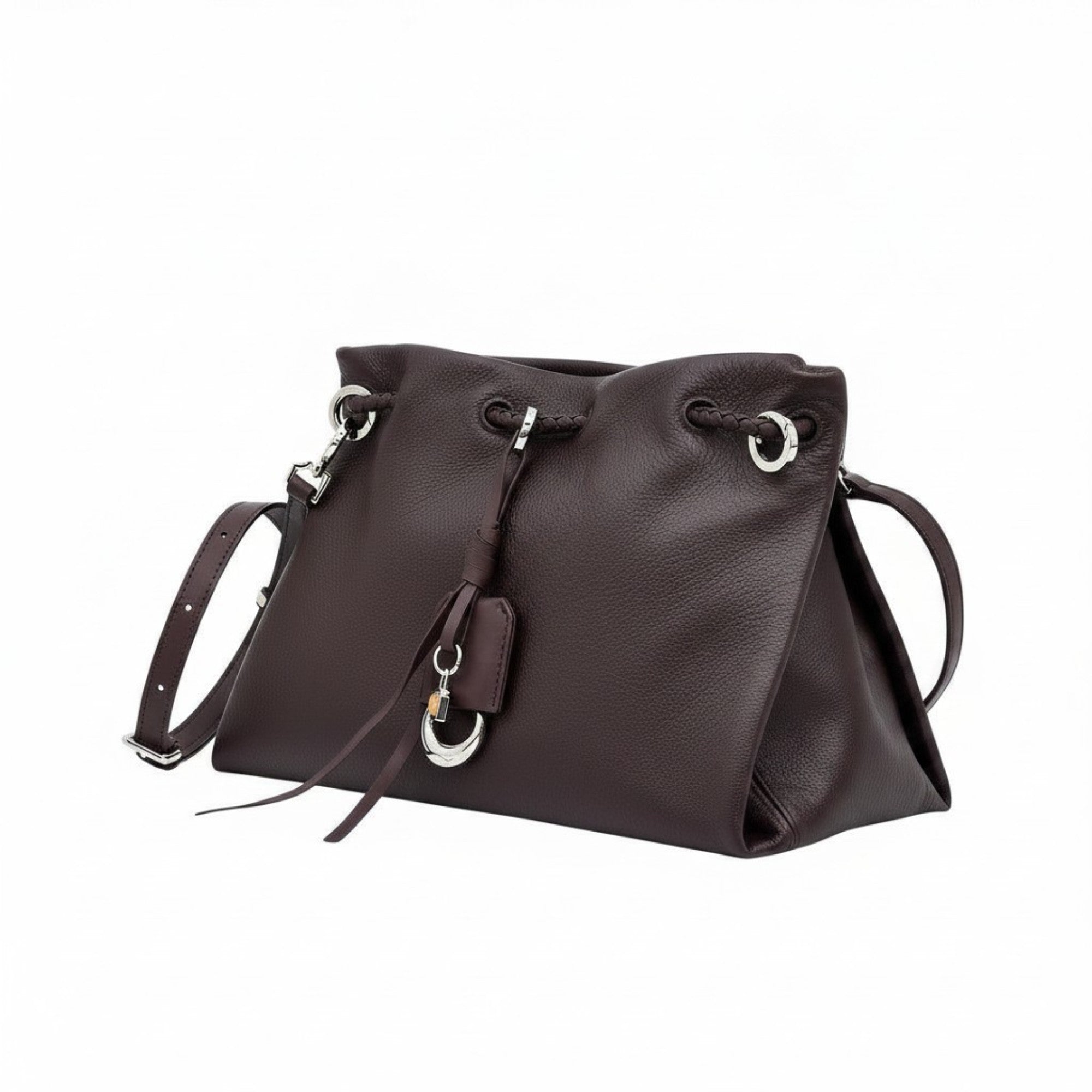 Side-angled view of a brown leather MUNI shoulder bag with tassel details, showcased by BLUE SALON.