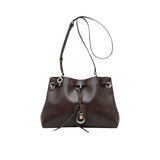Full front shot of a light green leather MUNI handbag with its shoulder strap extended vertically, from BLUE SALON.