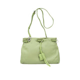 Full front shot of a light green leather MUNI handbag with its shoulder strap extended vertically, from BLUE SALON.