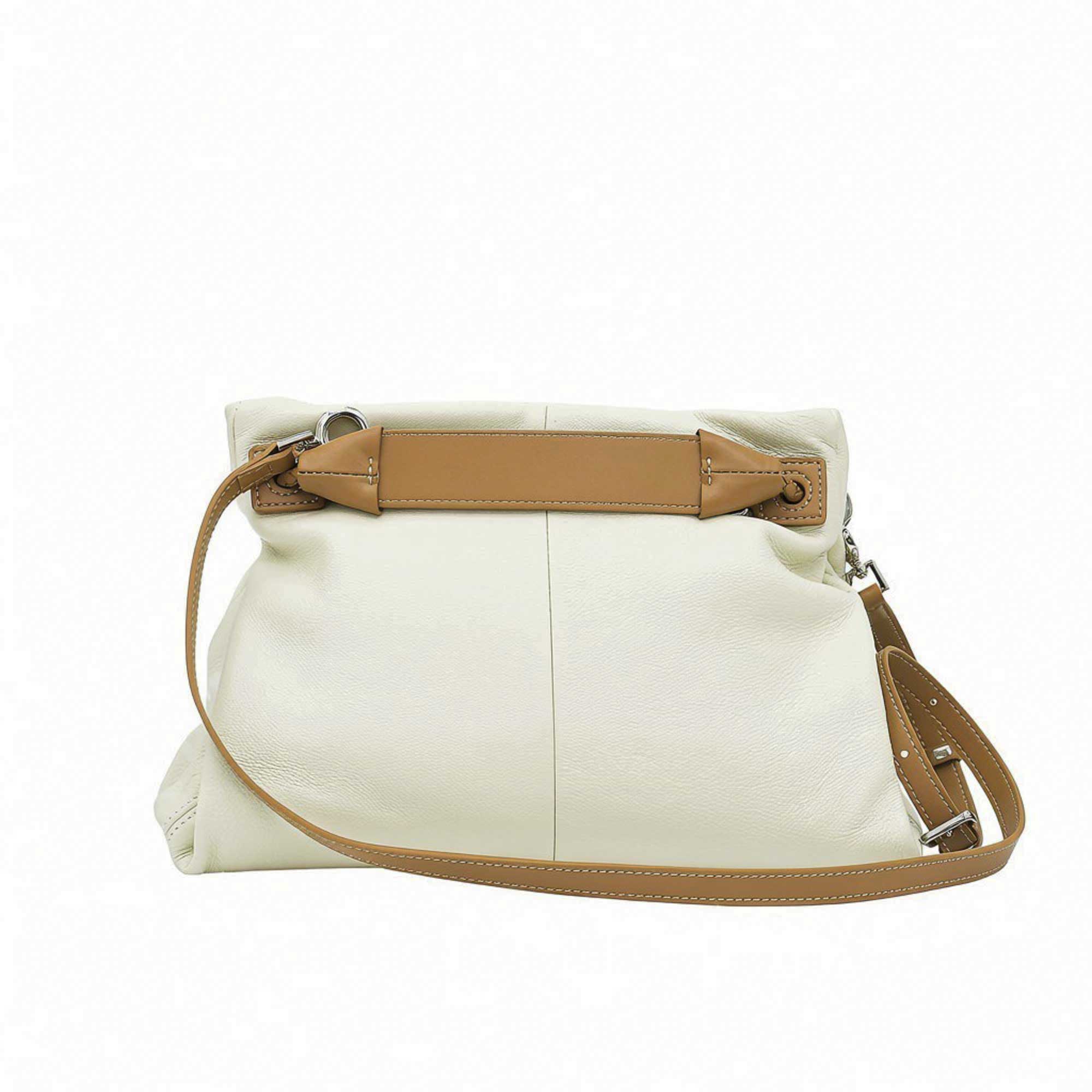 Back view of a light green MUNI leather shoulder bag showing the flat panel structure and strap attachments at BLUE SALON.